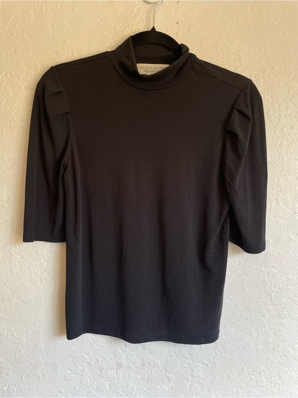 Saltwater Luxe black ribbed mockneck top‎ featuring distinctive puff sleeve